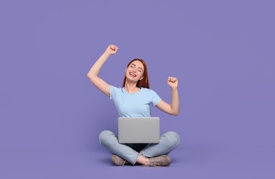 Photo of Happy young woman with laptop on lilac background