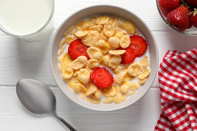 Photo of Corn flakes with strawberries in bowl served on white wooden table, flat lay