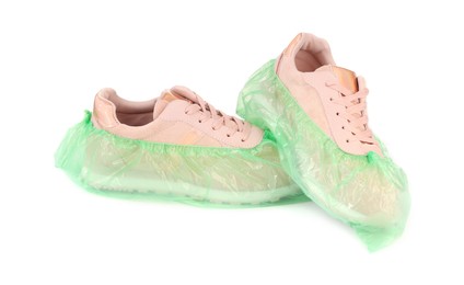 Sneakers in green shoe covers isolated on white