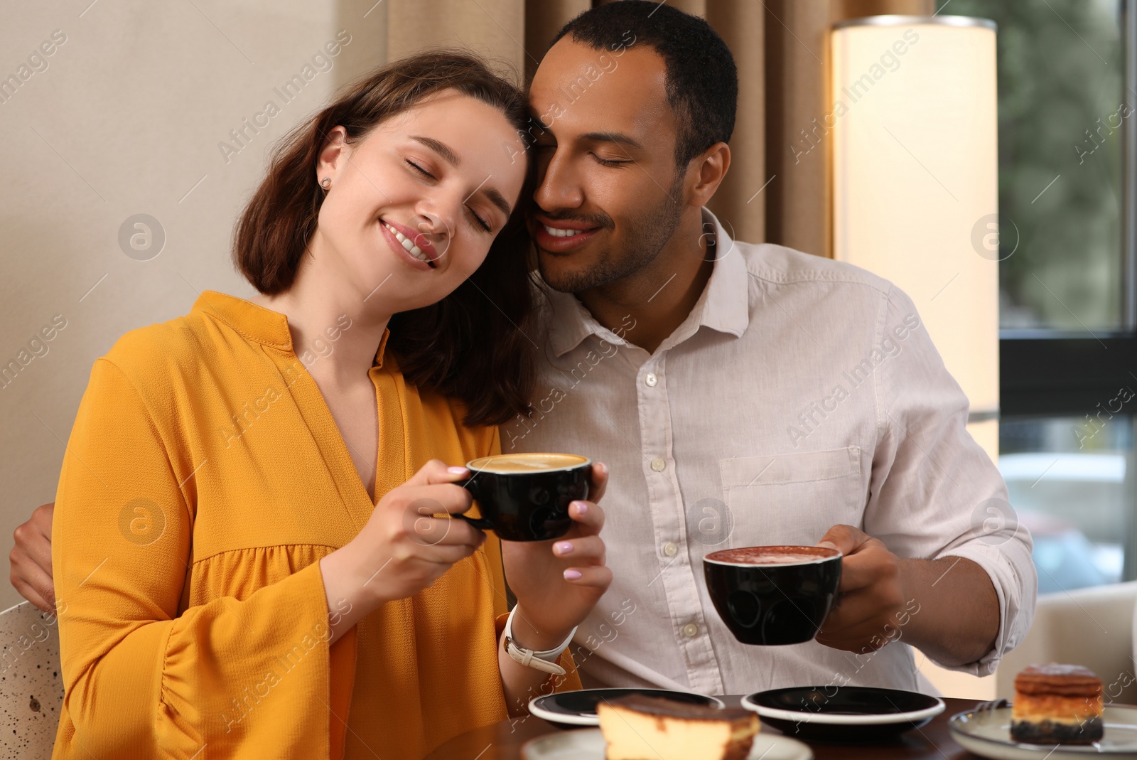 Photo of Romantic date. Happy couple spending time together in cafe