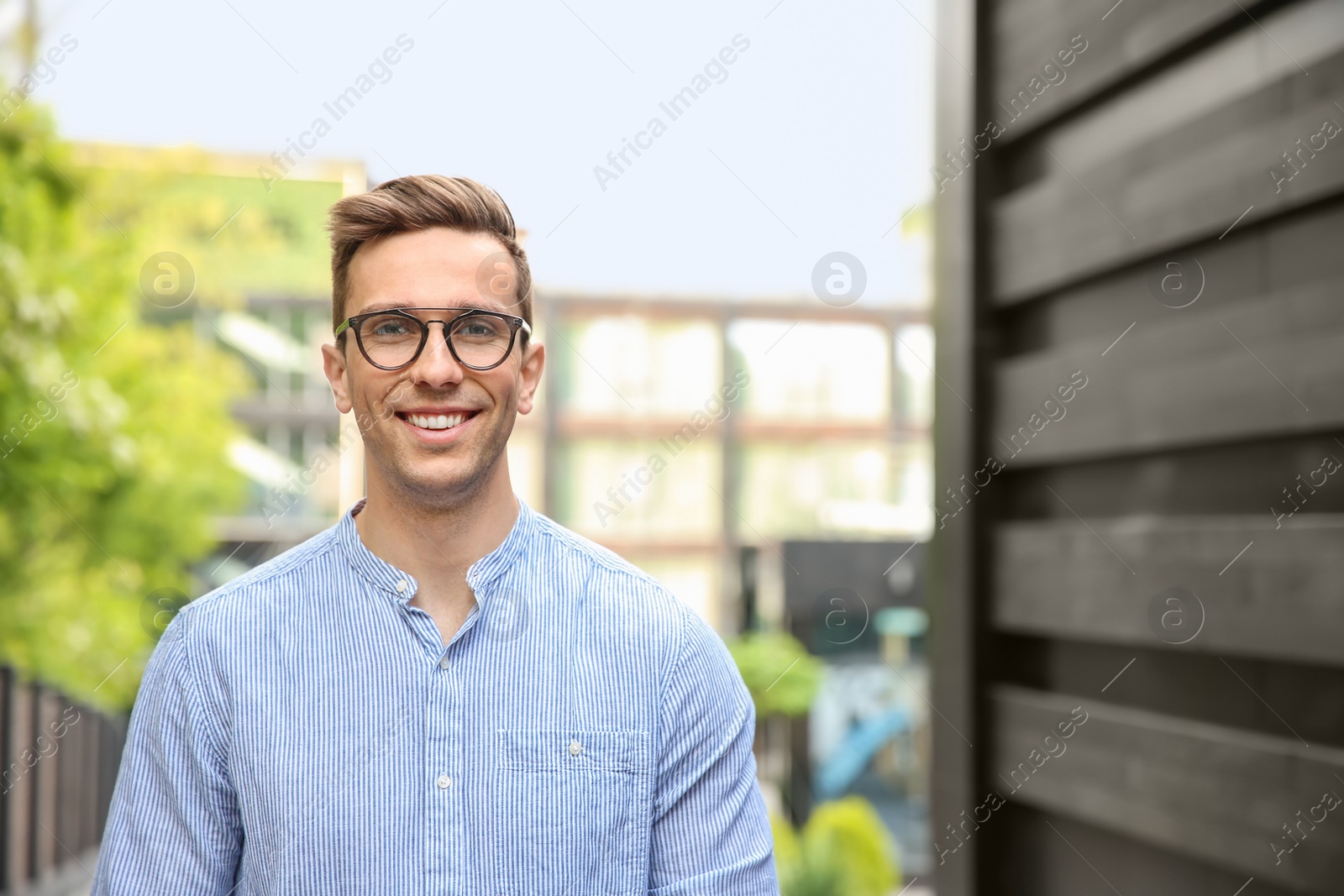 Photo of Portrait of attractive young man in stylish outfit outdoors