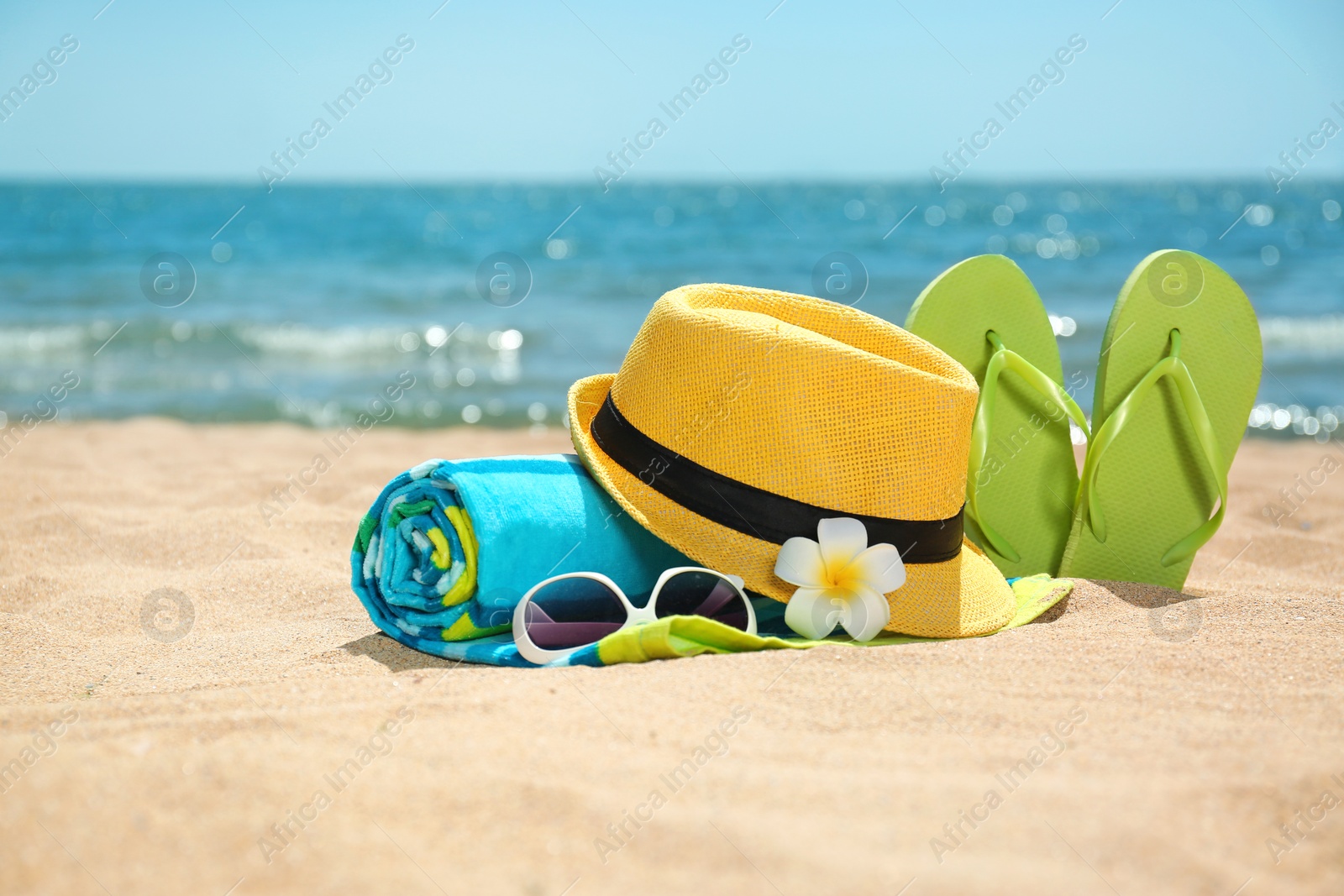 Photo of Set of different beach objects on sand near sea. Space for text