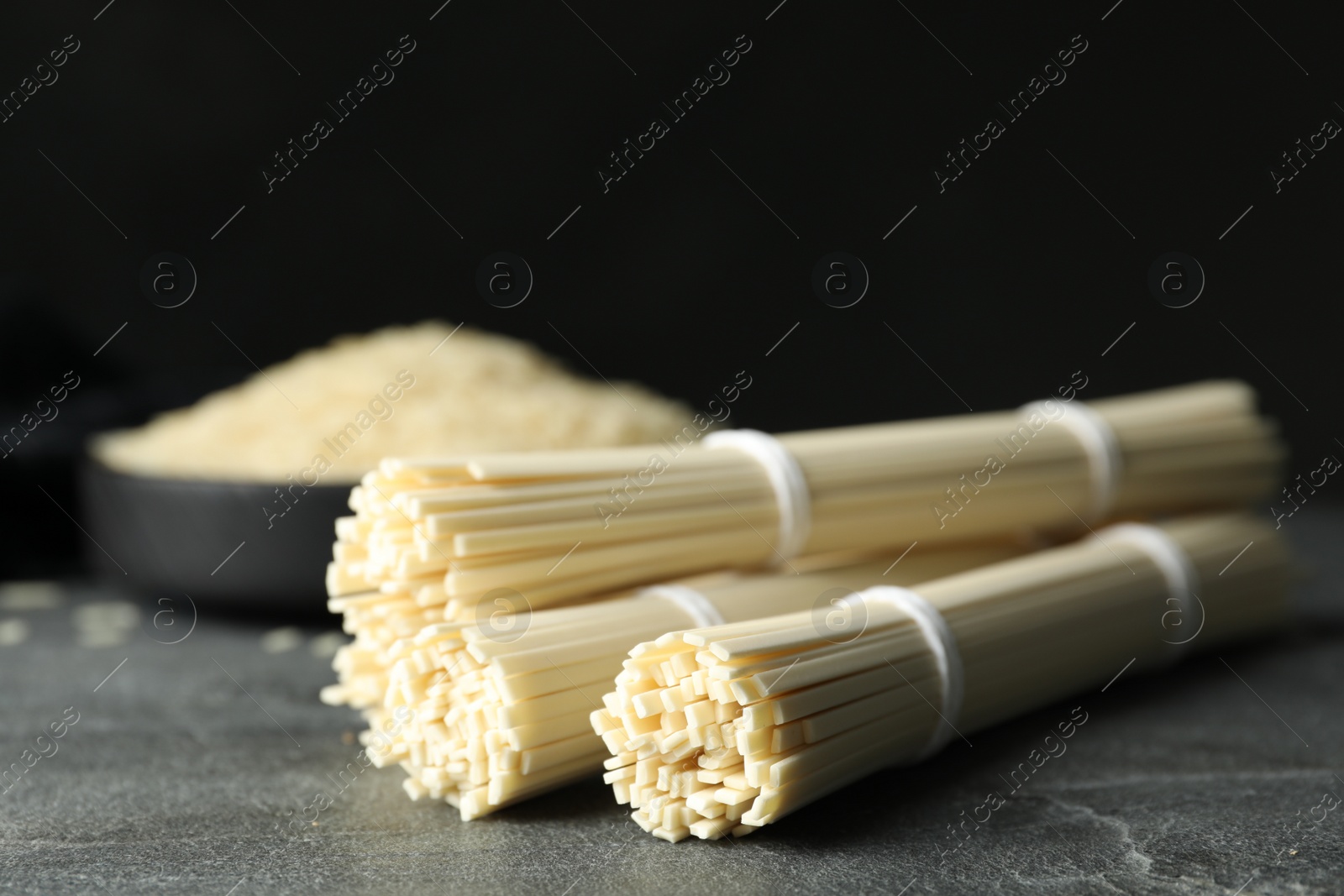 Photo of Raw rice noodles on grey table, closeup