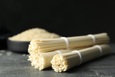 Photo of Raw rice noodles on grey table, closeup