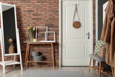 Photo of Hallway interior with stylish table and mirror