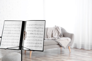 Note stand with music sheets indoors. Space for text