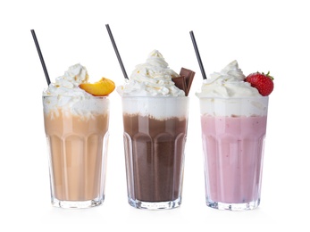 Photo of Glasses with delicious milk shakes on white background