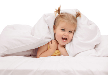 Photo of Cute little child playing under blanket in bed