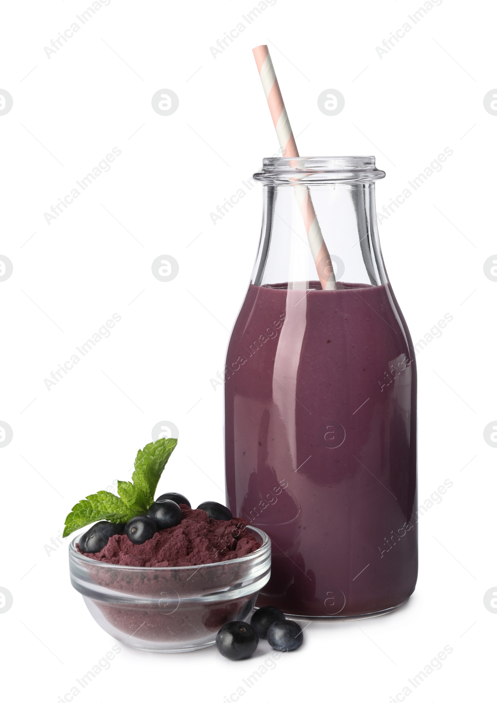 Photo of Glass bottle of acai drink with berries and powder on white background