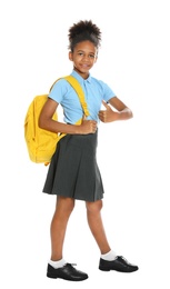 Happy African-American girl in school uniform on white background