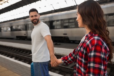 Photo of Long-distance relationship. Couple walking on platform of railway station