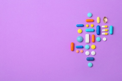 Many different pills and space for text on color background, top view