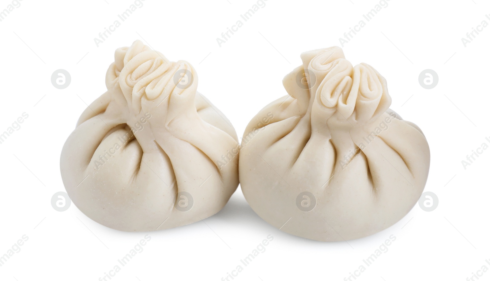 Photo of Uncooked khinkali (dumplings) isolated on white. Georgian cuisine