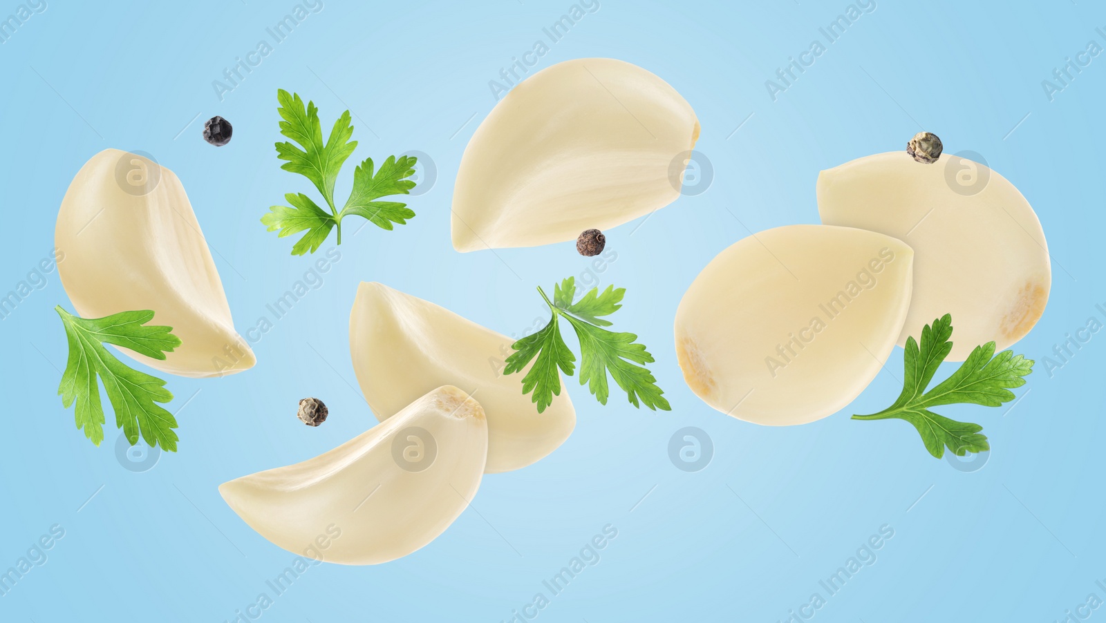 Image of Fresh garlic cloves, parsley and peppercorns falling on light blue background, banner design