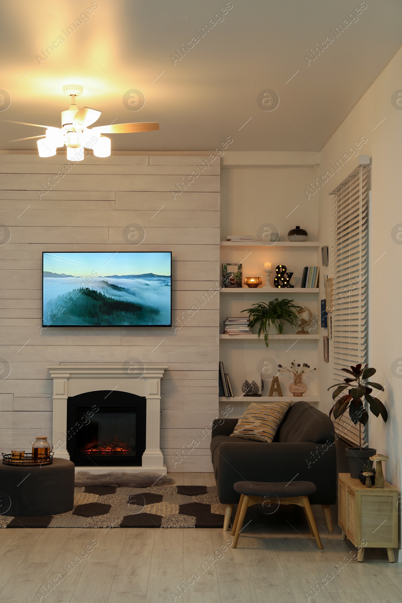 Photo of Cozy living room interior with comfortable sofa and decorative fireplace