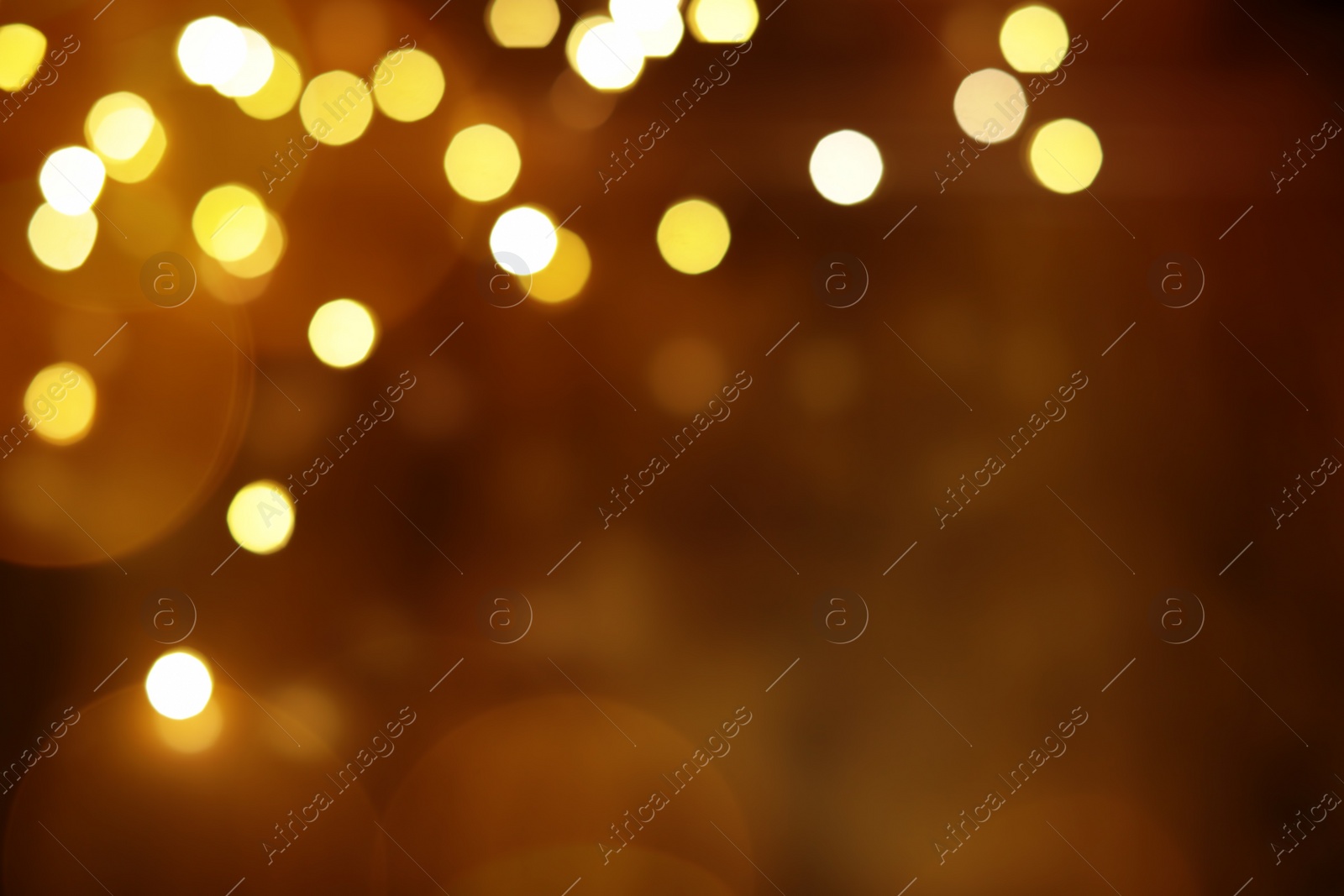 Photo of Blurred view of glowing lights on color background. Winter holiday