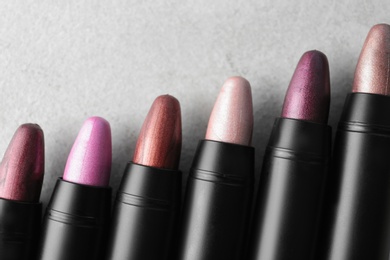 Photo of Set of bright lipsticks on grey background, flat lay. Space for text