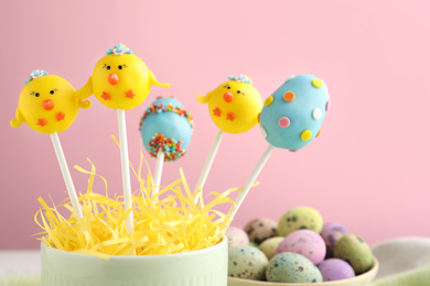 Photo of Delicious sweet cake pops on pink background, closeup. Easter holiday