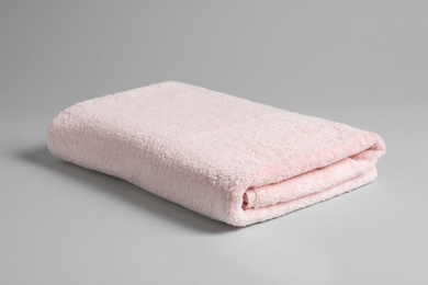Photo of Fresh soft folded towel on light background
