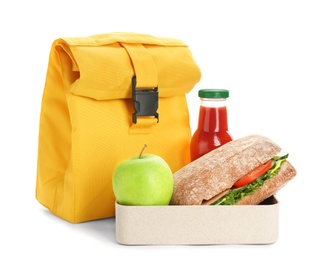 Lunch box with appetizing food, bottle of juice and bag on white background