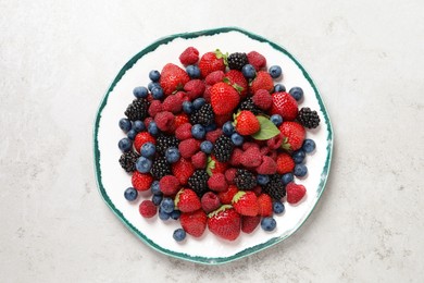 Different fresh ripe berries on light grey table, top view