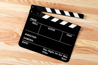 Photo of One clapperboard on wooden table, top view