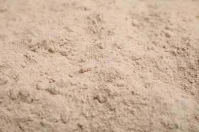 Photo of Pile of buckwheat flour as background, closeup