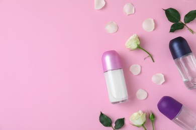 Photo of Flat lay composition with different female roll-on deodorants on pink background, space for text