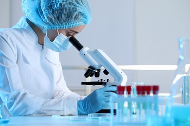 Photo of Scientist working with microscope in laboratory. Medical research