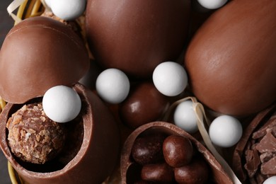 Tasty chocolate eggs and sweets as background, closeup