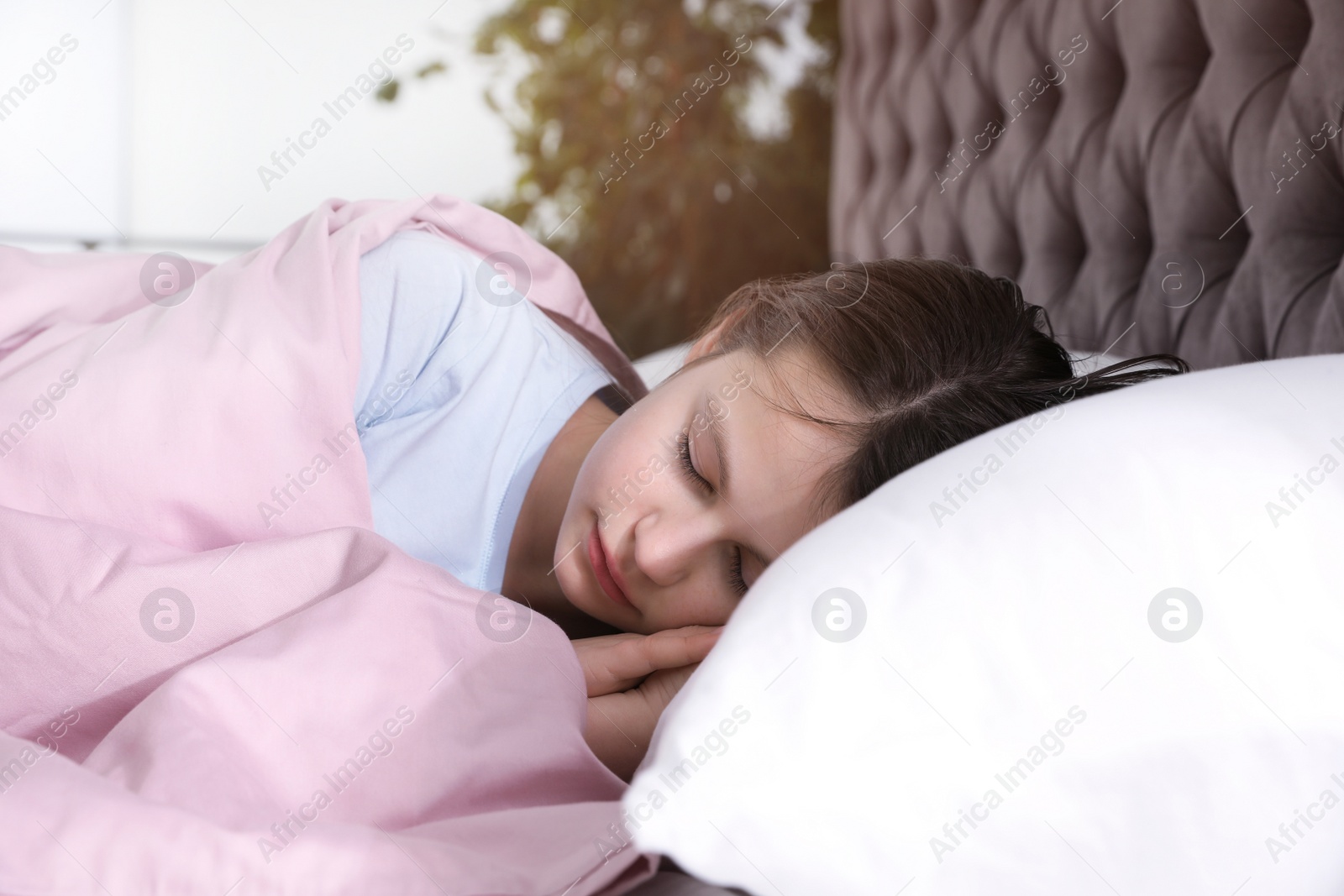 Photo of Beautiful little girl sleeping in bed at home