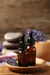 Cosmetic products and lavender flowers on wooden table