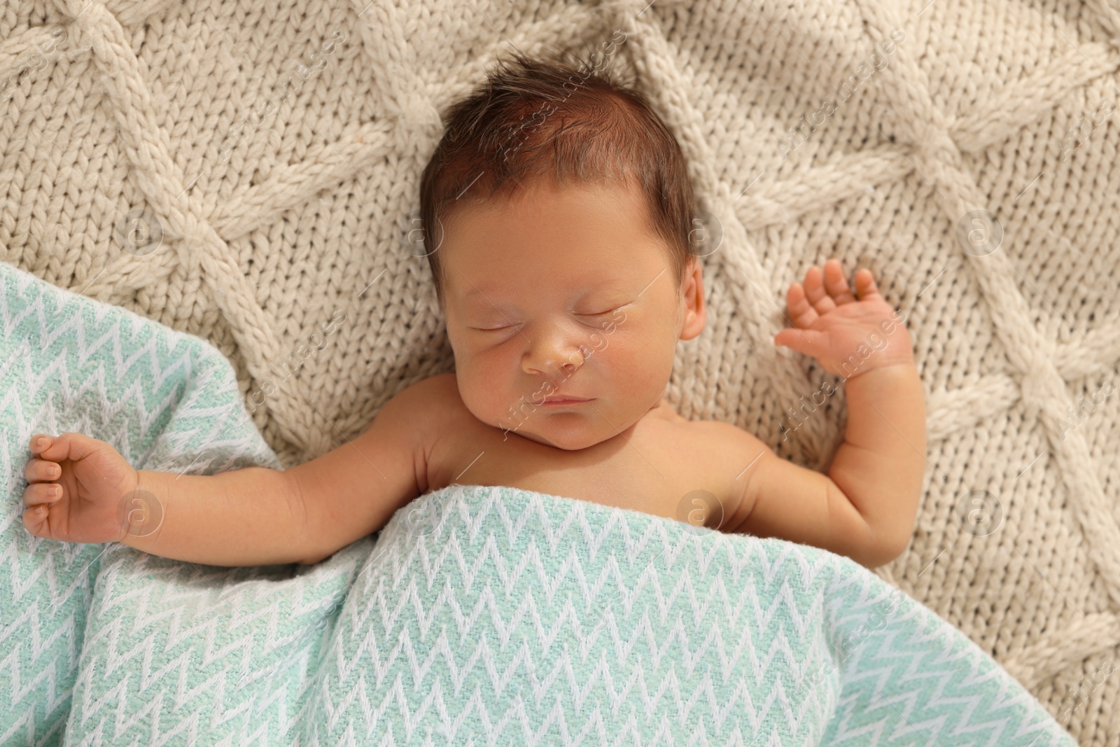 Photo of Cute newborn baby sleeping on beige blanket, top view