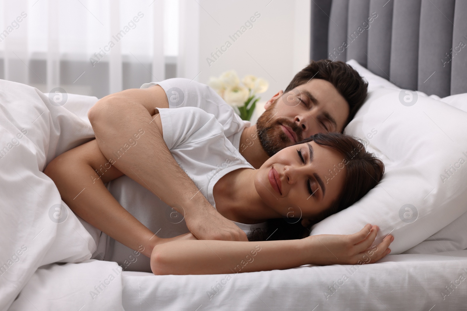 Photo of Lovely couple sleeping together in bed at home