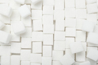 Photo of White sugar cubes as background, top view