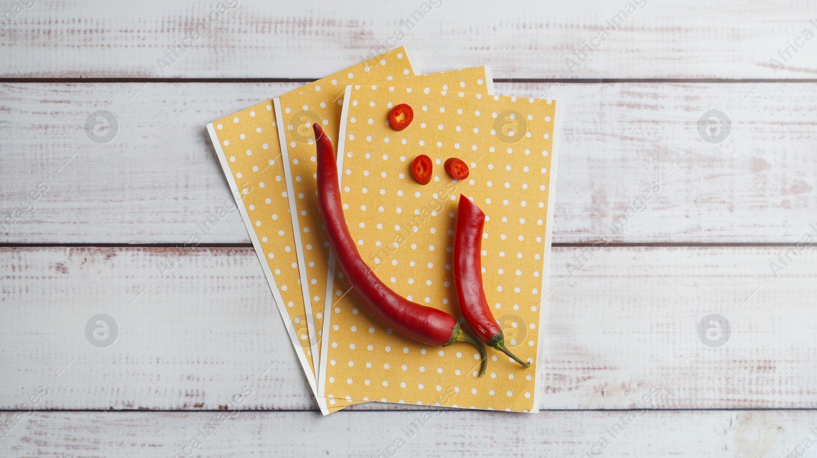 Photo of Pepper plasters and chili on white wooden table, top view