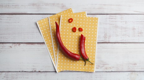 Photo of Pepper plasters and chili on white wooden table, top view