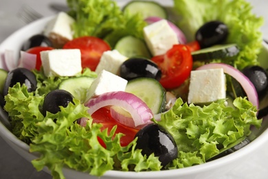 Tasty fresh Greek salad in  bowl, closeup