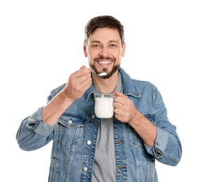 Photo of Handsome man with tasty yogurt on white background