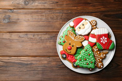 Photo of Different tasty Christmas cookies on wooden table, top view. Space for text