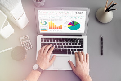 Image of Man using laptop at table, top view. Business analytics