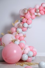 Photo of Beautiful composition with balloons and spikelets near light wall