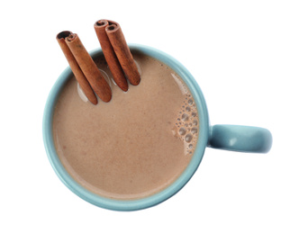 Delicious cocoa drink with cinnamon sticks on white background, top view