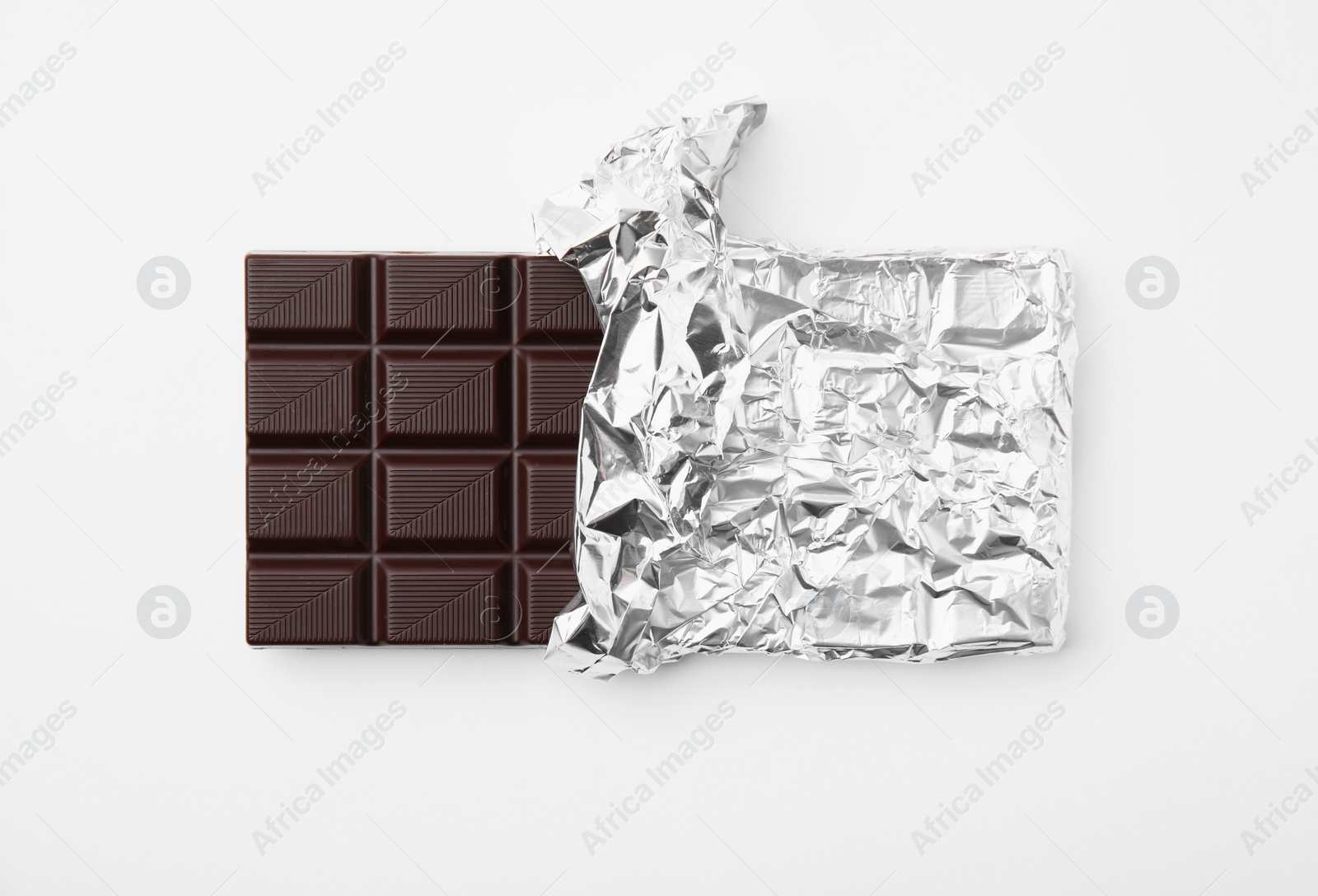 Photo of Tasty chocolate bar on white background, top view