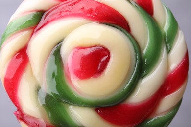 Colorful lollipop swirl on grey background, closeup