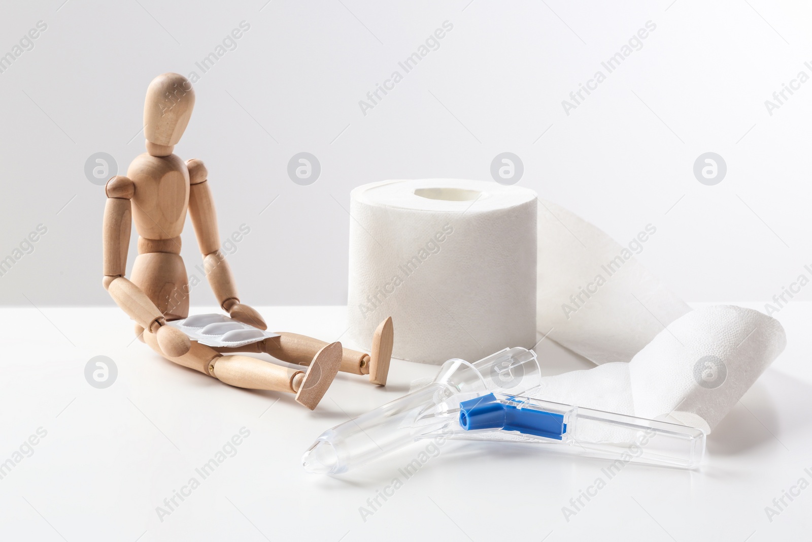 Photo of Composition with anoscope on white background. Hemorrhoid treatment