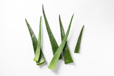 Photo of Green aloe vera leaves on white background, flat lay