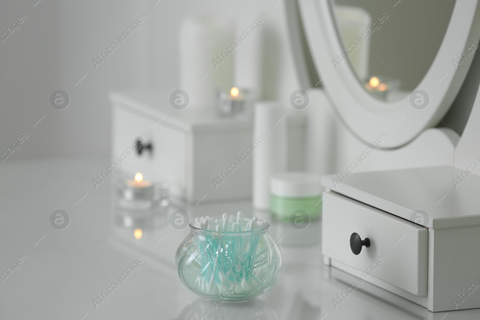 Photo of Cotton buds on dressing table in bathroom. Space for text