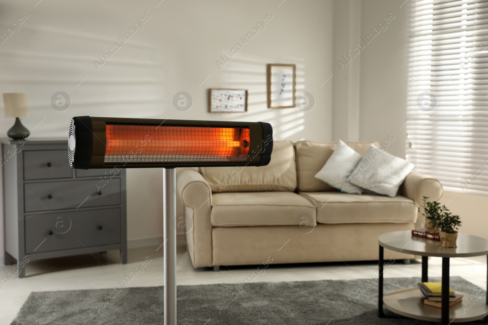 Photo of Modern electric infrared heater in living room