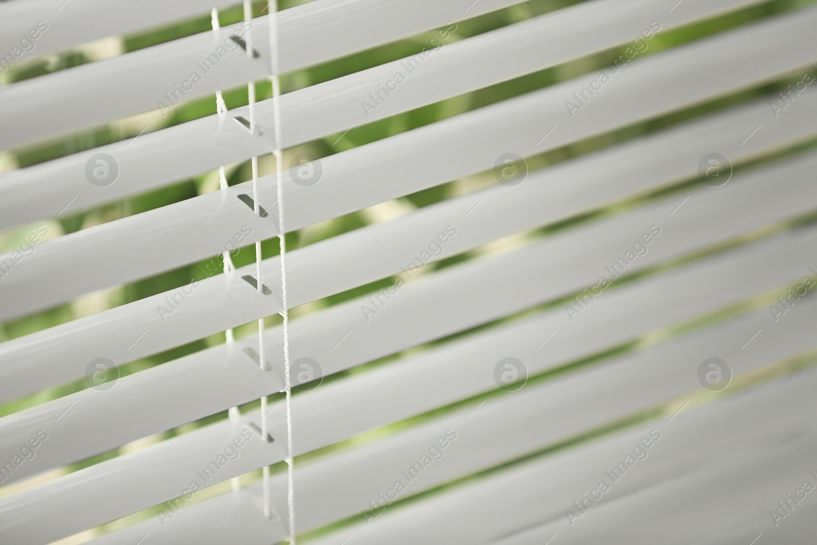 Photo of Closeup view of window with horizontal blinds